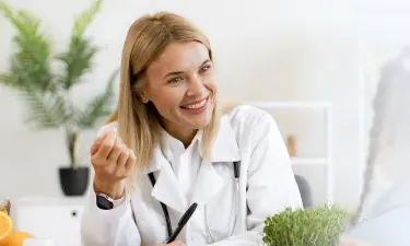 Kansas family nurse practitioner smiling with pediatric patient during appointment